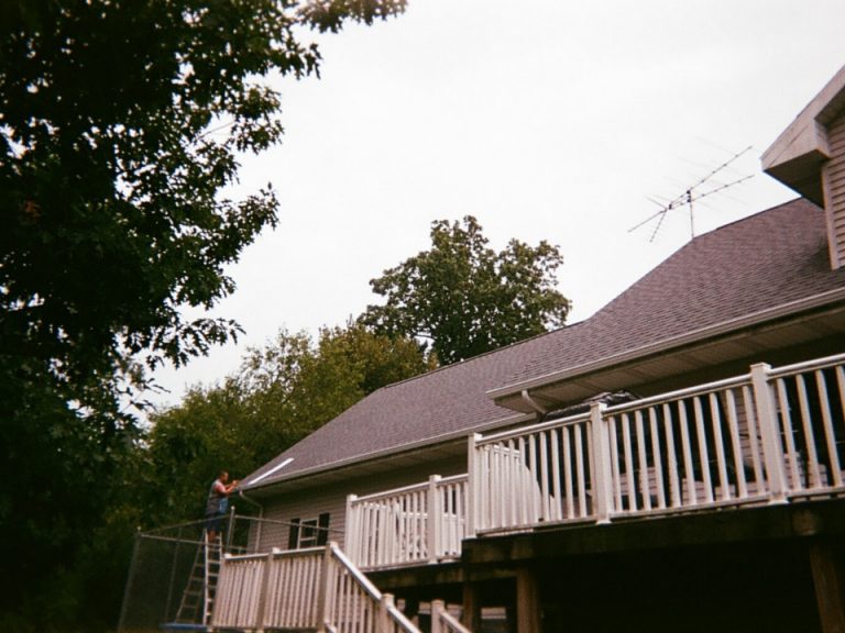 one of our specialists working on replacing a shingle